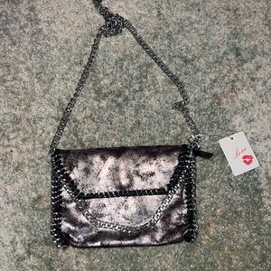 Trendy black and silver shoulder bag with chain detail.